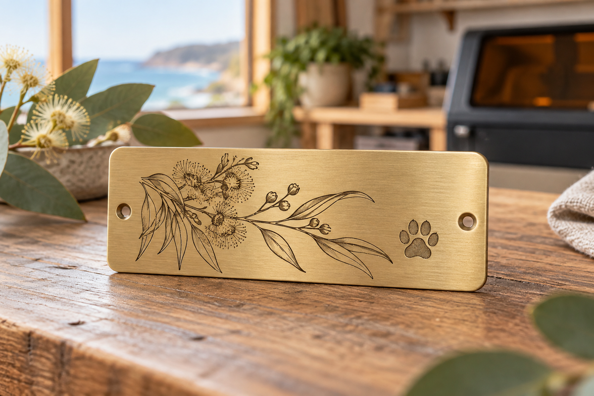 Brass keepsake plaque with crisp laser-engraved botanical artwork and a paw print.