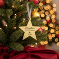 Decorative Christmas ornament with a gold star tag on a green fabric background