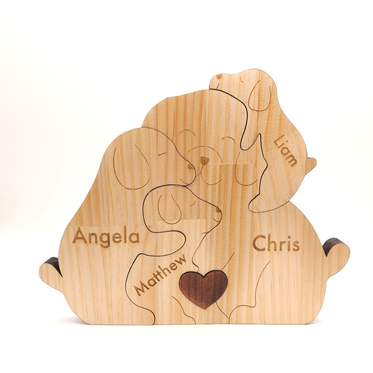 Wooden puzzle shaped like a heart with names engraved on it, on a white background