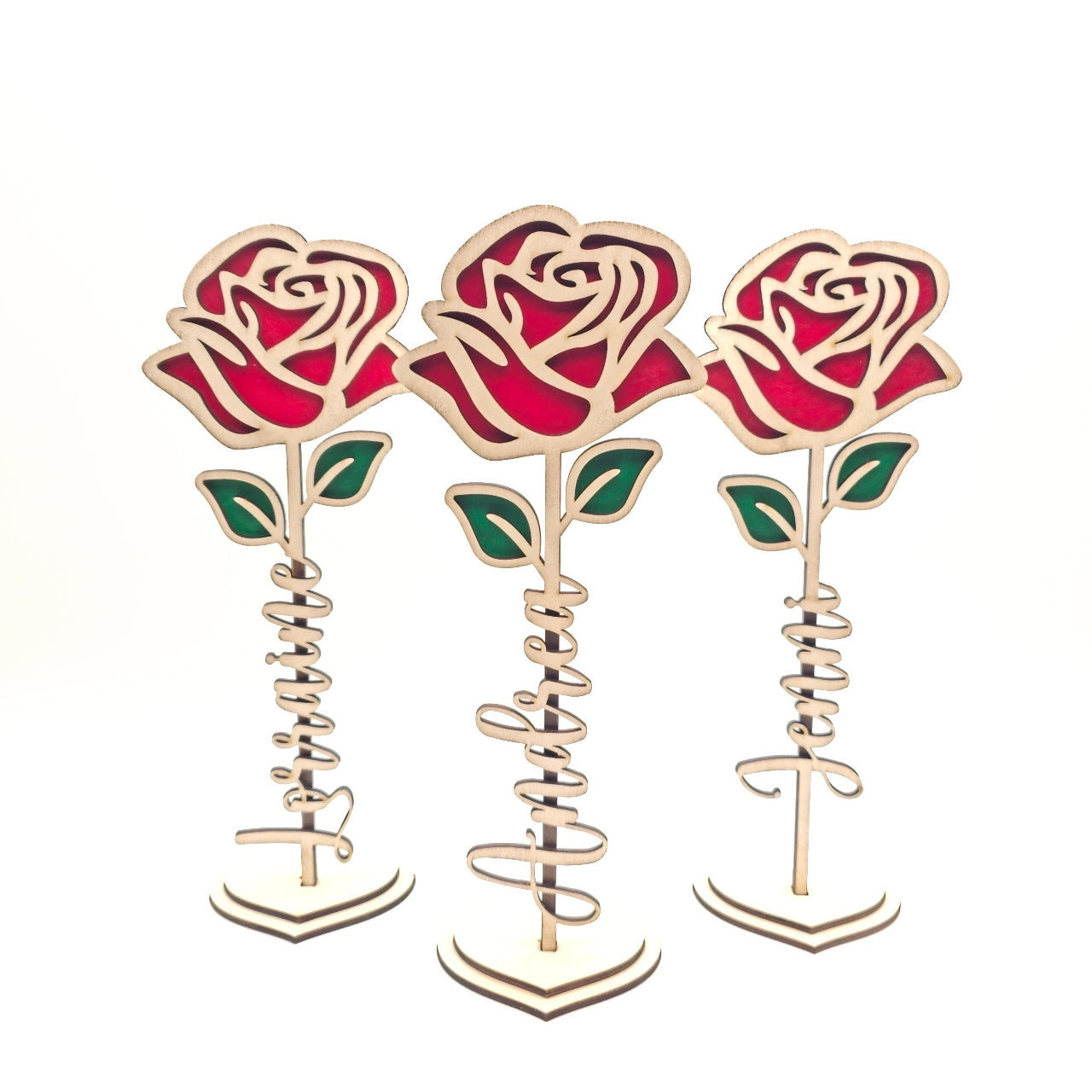 Three red rose-shaped candle holders on a white background