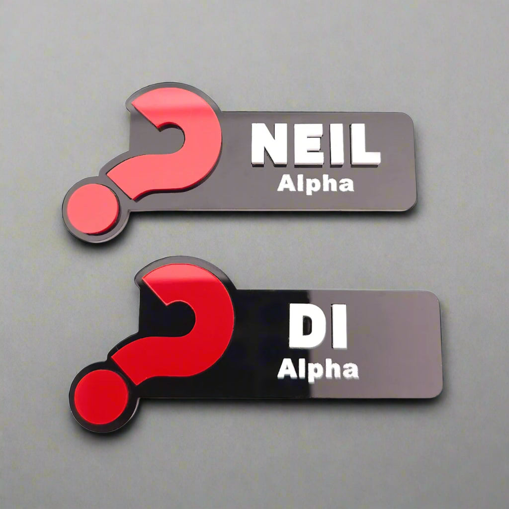 Two name tags with red question marks and text on a white background