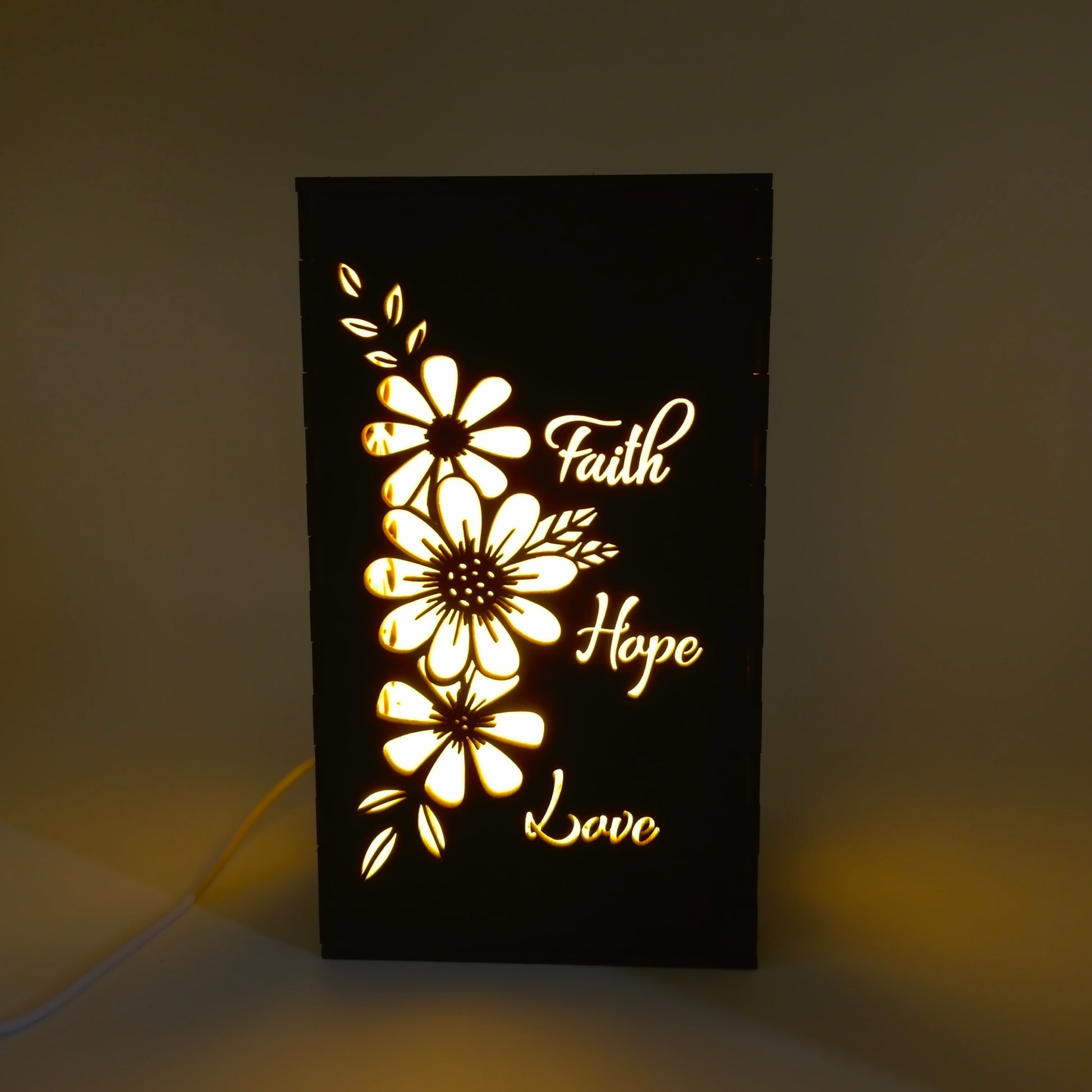 Decorative light panel with floral designs and 'Faith Hope Love' text on a dark background