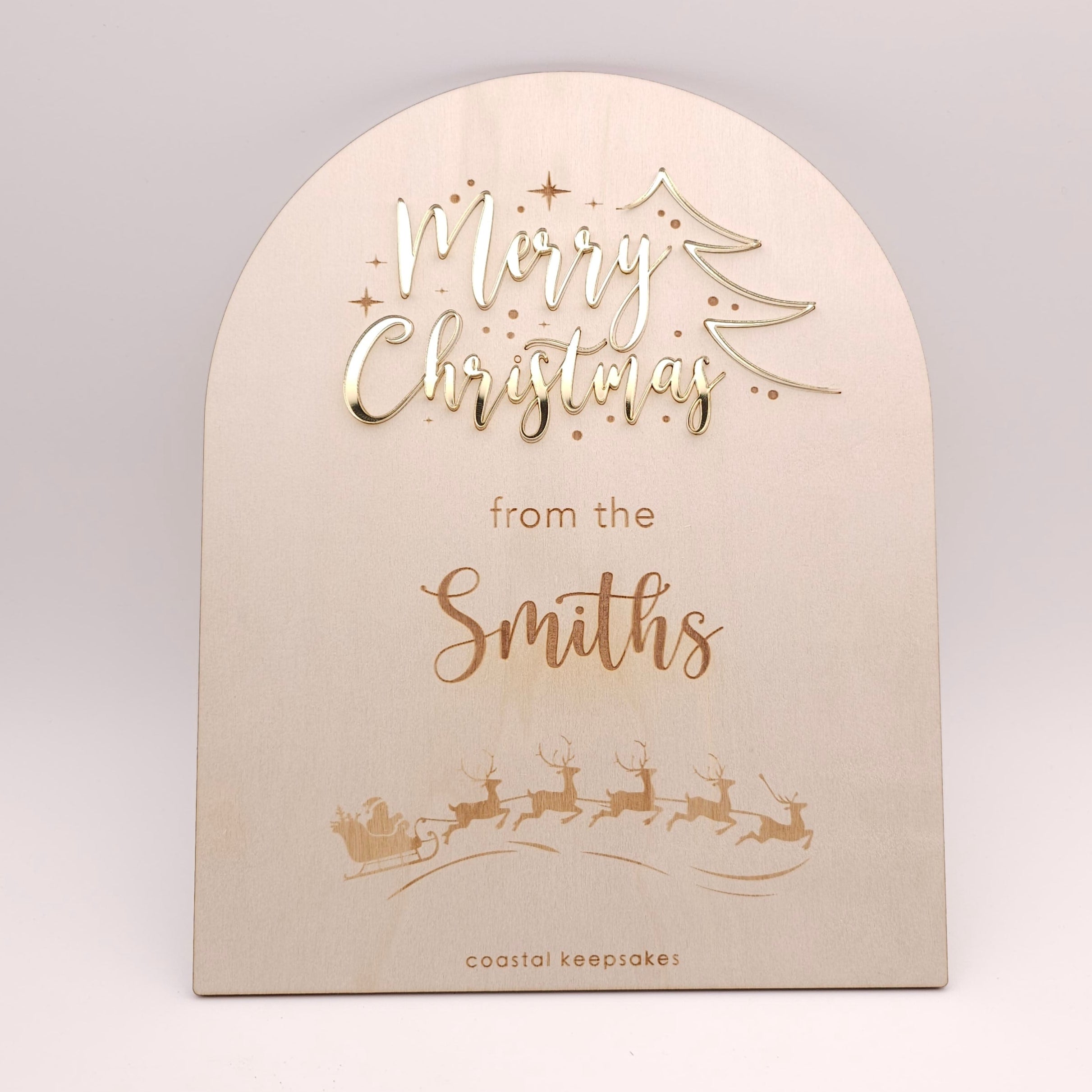 Beige Christmas card with gold text and reindeer illustration on a light gray background