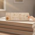 Wooden bookmark with sunflower design on a stack of books with a cozy background