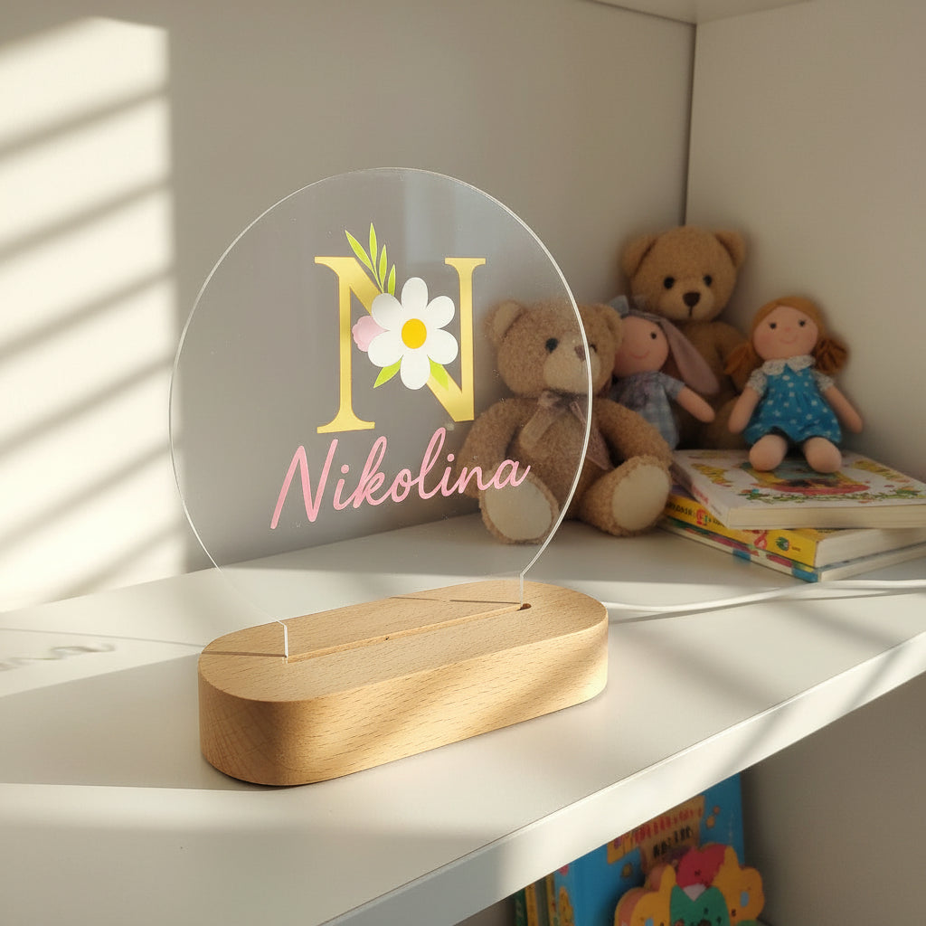 Decorative nameplate with 'Nikolina' and floral design on a white background