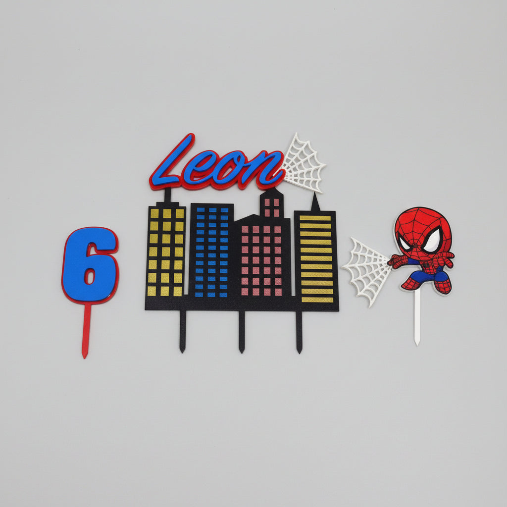 Children's birthday cake topper with 'Leon' and number '6', featuring a cityscape and Spider-Man character.