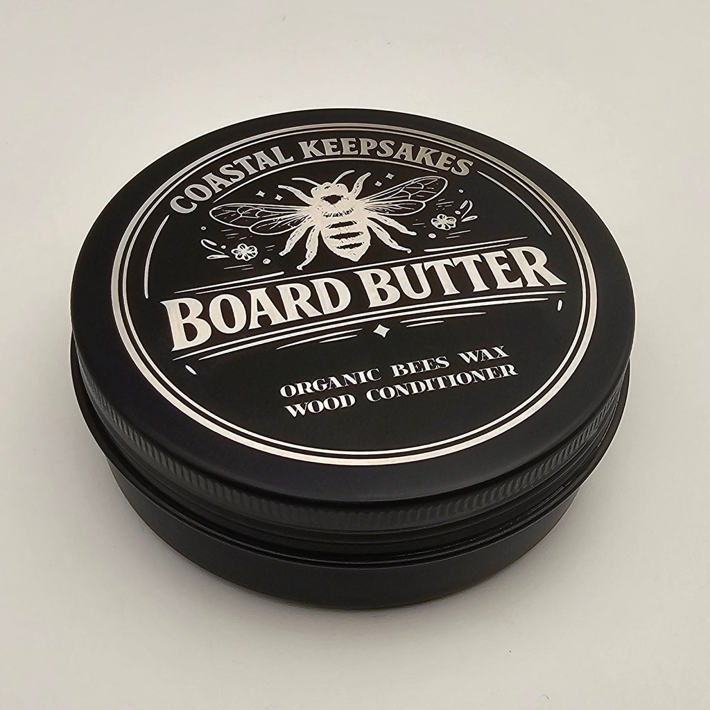 Black container of Board Butter on a light gray background