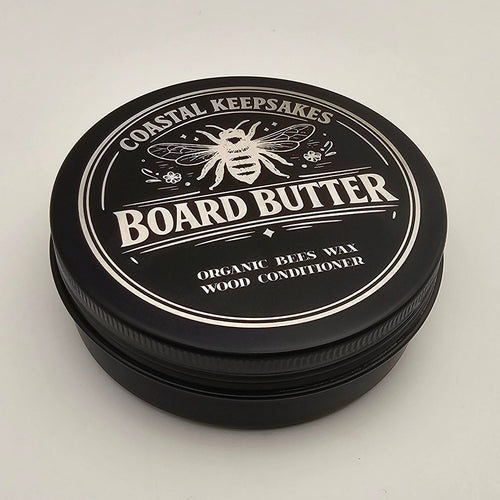 Black container of Board Butter on a light gray background