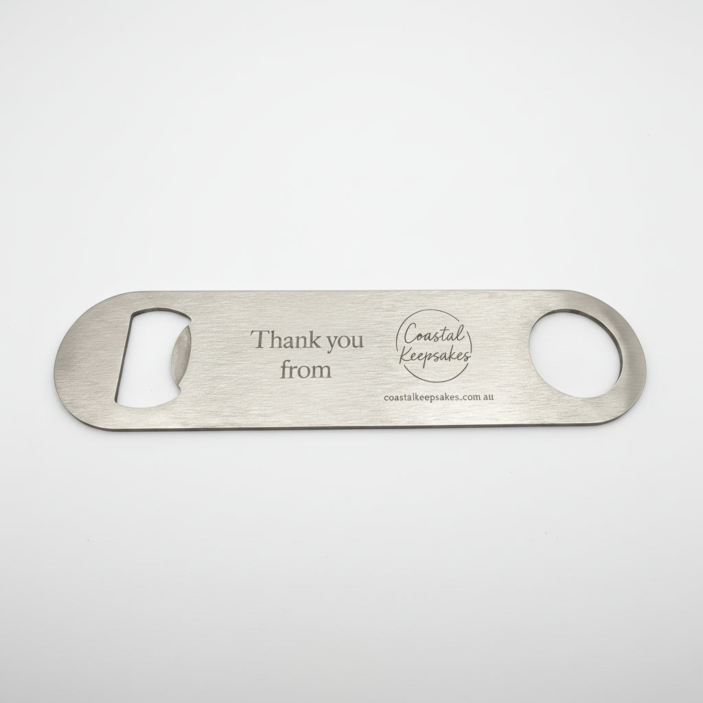 Metal bottle opener with 'Thank you from Coastal Keepsakes' engraving on a white background