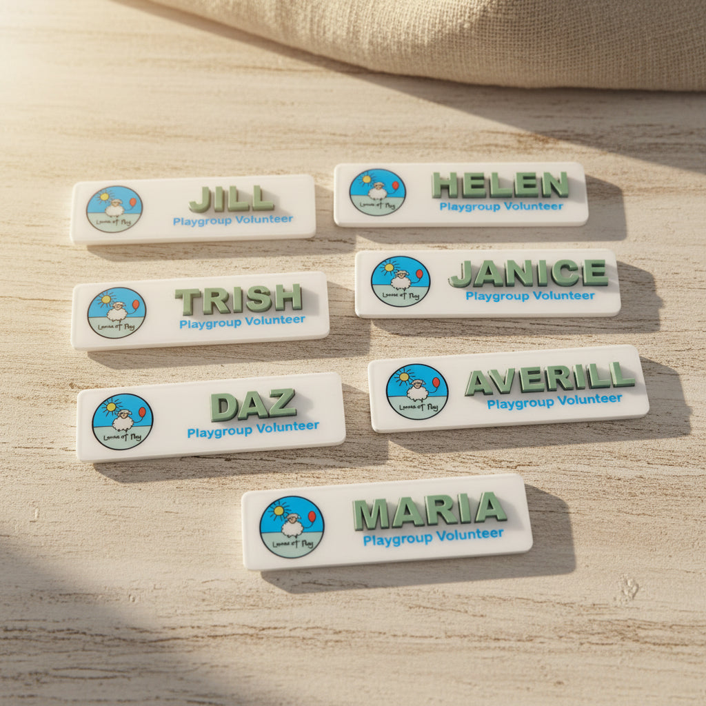 Set of name badges for playgroup volunteers on a white background