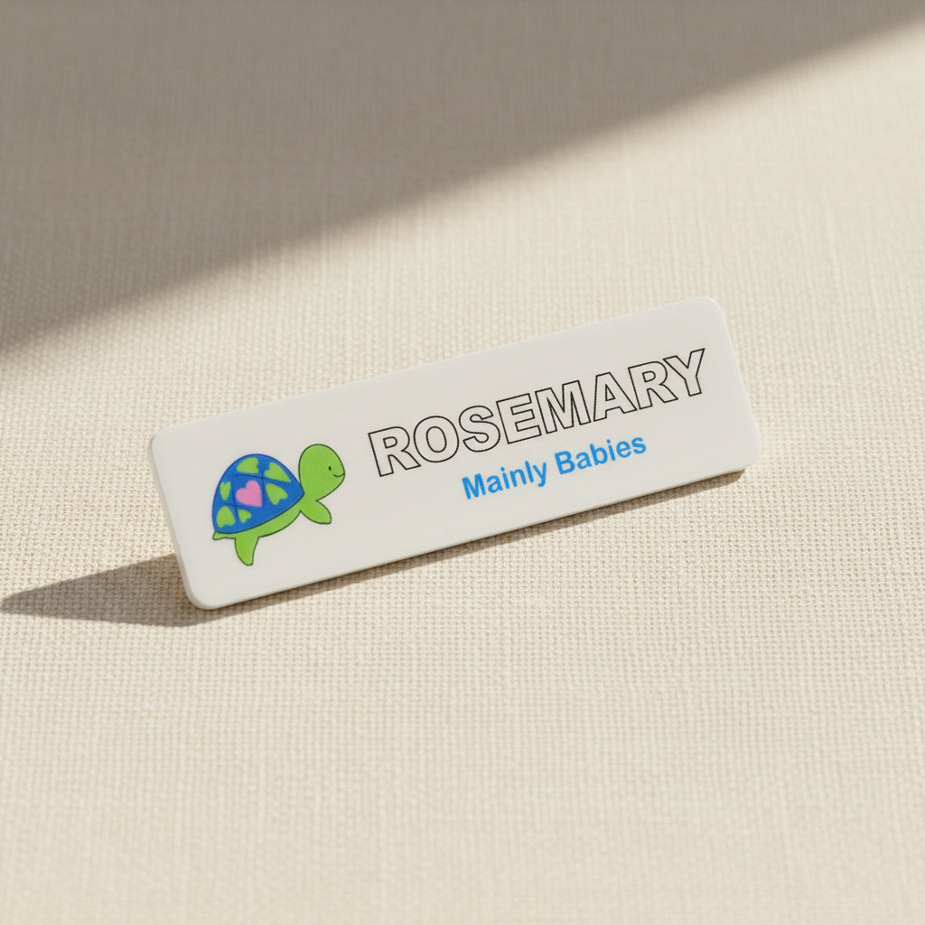 Name tag with a turtle illustration and text on a white background