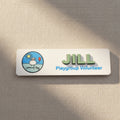 Name tag with 'JILL' and 'Playgroup Volunteer' text on a white background