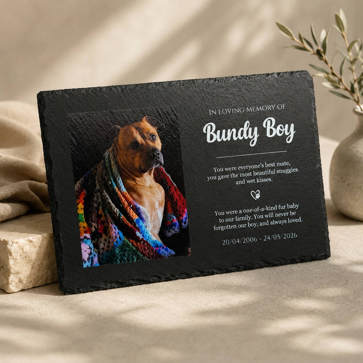 Memorial slate plaque for a dog named Bundy Boy with a photo and text on a neutral background.