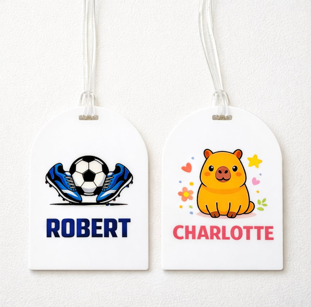 Two luggage tags with cartoon designs and names 'Robert' and 'Charlotte'.