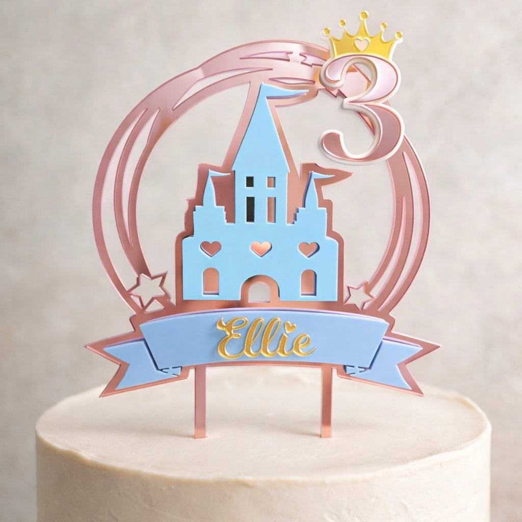Cake topper with castle design and 'Ellie' on a white background