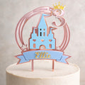 Cake topper with castle design and 'Ellie' on a white background