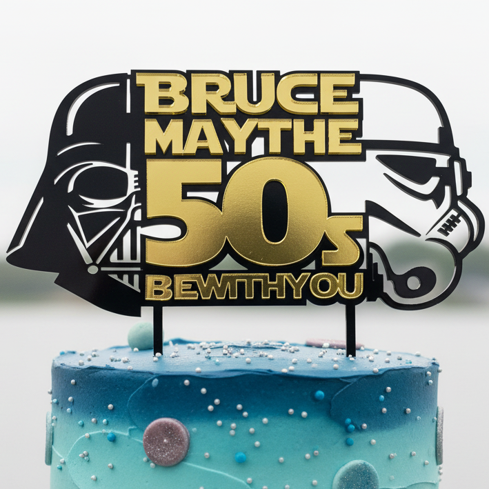 Cake topper with Star Wars characters and text 'Bruce May the 50s Be with you' on a blue cake.