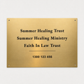 Gold plaque with text for Summer Healing Trust and related organizations on a white background