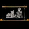 Clear crystal block with engraved image of a boy and dog on a black background