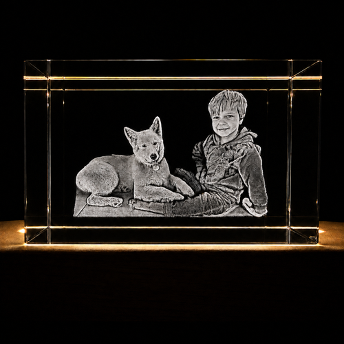 Clear crystal block with engraved image of a boy and dog on a black background