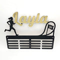 Metal wall art with 'Layla' and a running silhouette on a white background