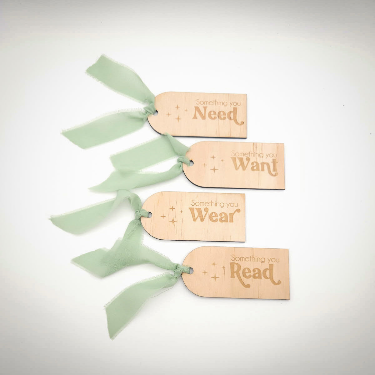 Wooden tags with text and ribbons on a white background