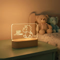 LED lamp with dinosaur design and 'Good Night Little Dino' text on a wooden surface.
