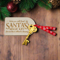 Gold key with red ribbon on a white background