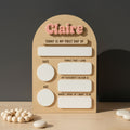 Wooden plaque with cut-out letters spelling 'Claire' on a textured surface