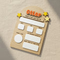 Wooden board with 'Ottar' branding and text for tracking a child's milestones on a black background.