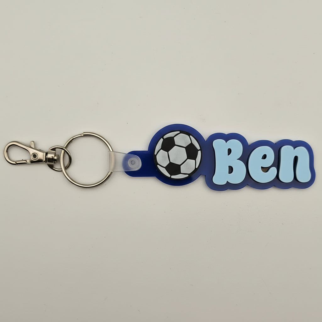 Keychain with soccer ball design and 'Ben' text on a beige background