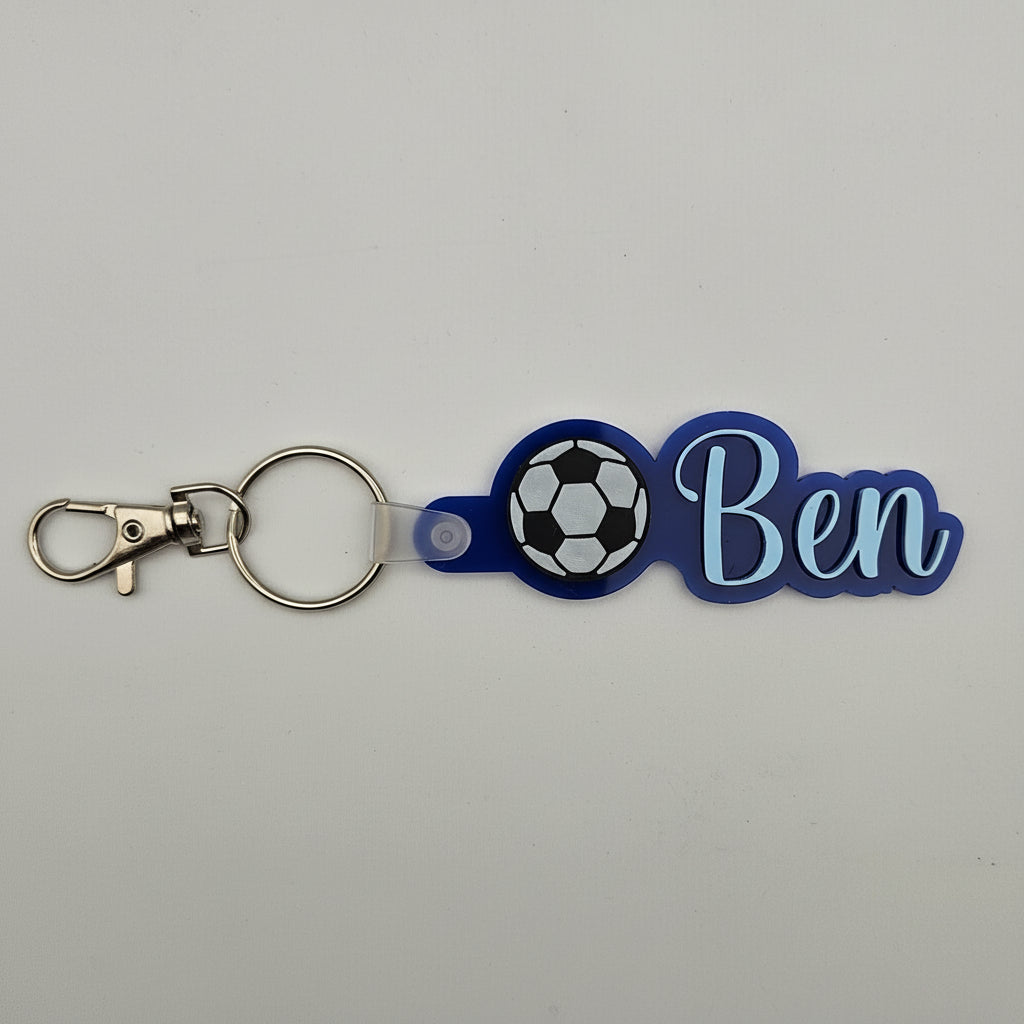 Keychain with soccer ball design and 'Ben' text on a gray background