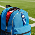 Blue backpack with a soccer ball design on a grass field
