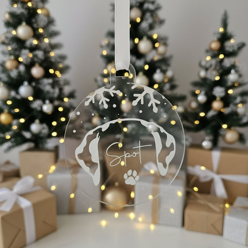 Round decorative tag with paw prints and 'Spot' text, hanging against a festive background with Christmas ornaments.