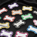 Colorful bone-shaped pet tags on a white background