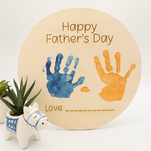 Round wooden plaque with handprints and 'Happy Father's Day' text on a white background