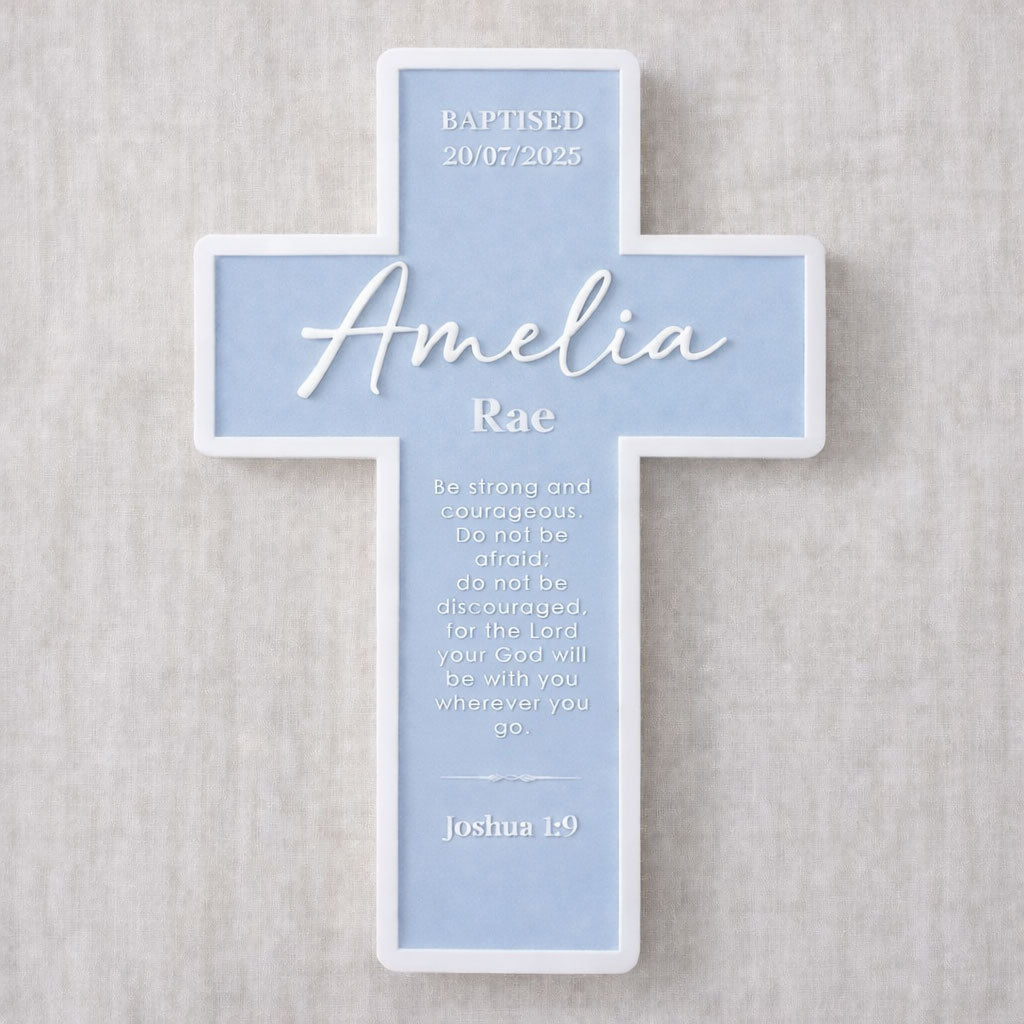 Decorative cross with personalized name and text on a light blue background