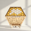 Hexagonal wooden display with honeycomb design and engraved names on a gray background