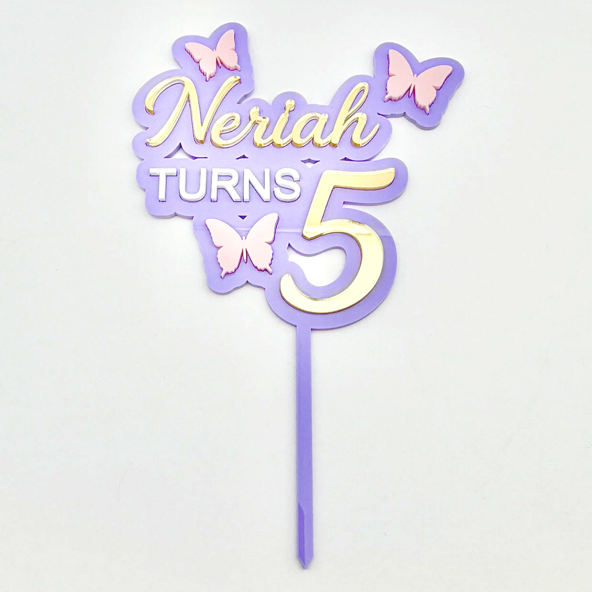 Layered acrylic butterfly birthday cake topper in purple, pink and gold acrylic