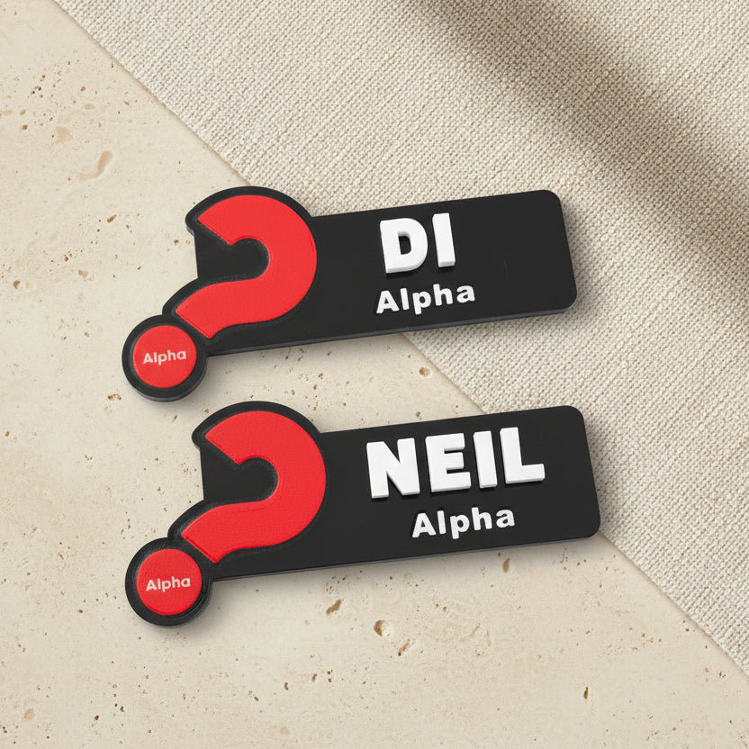 Two name tags with red question marks and text on a beige background
