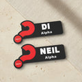 Two name tags with red question marks and text on a beige background