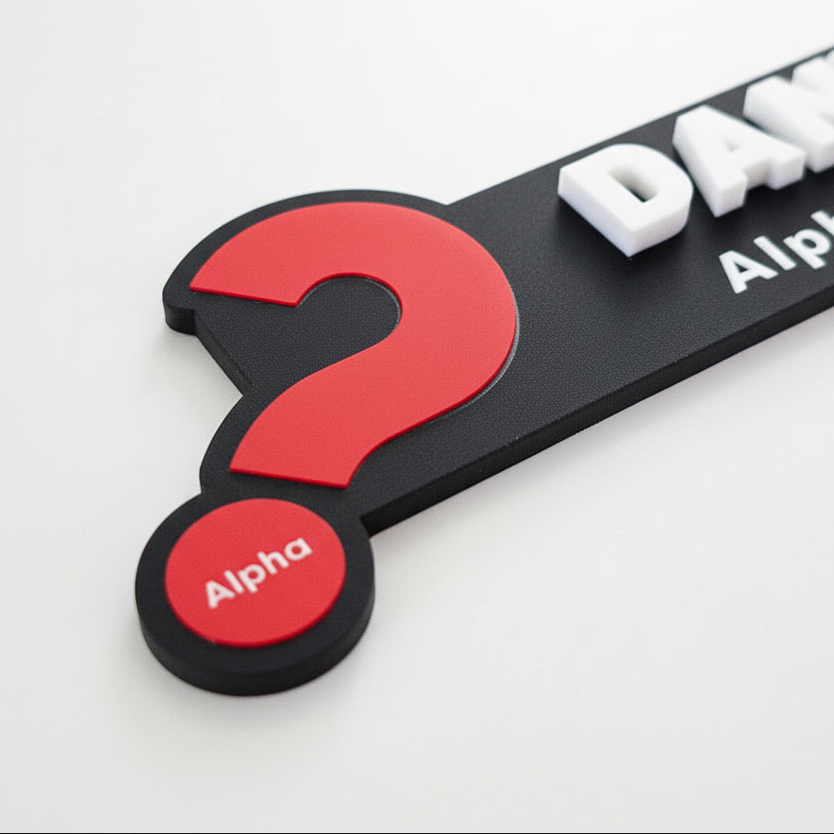 Black and red product with a question mark and 'Alpha' branding on a textured surface