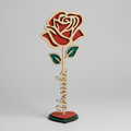 Wooden rose decorative item with 'Husband' on a wooden base, surrounded by plants.