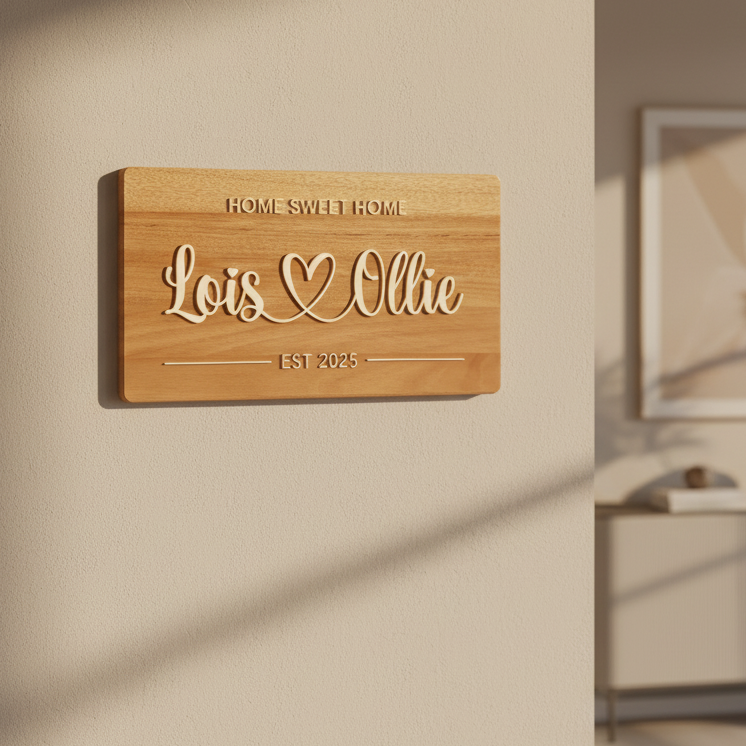 Wooden sign with 'Home Sweet Home' and 'Lois Ollie EST 2025' on a brown fabric background