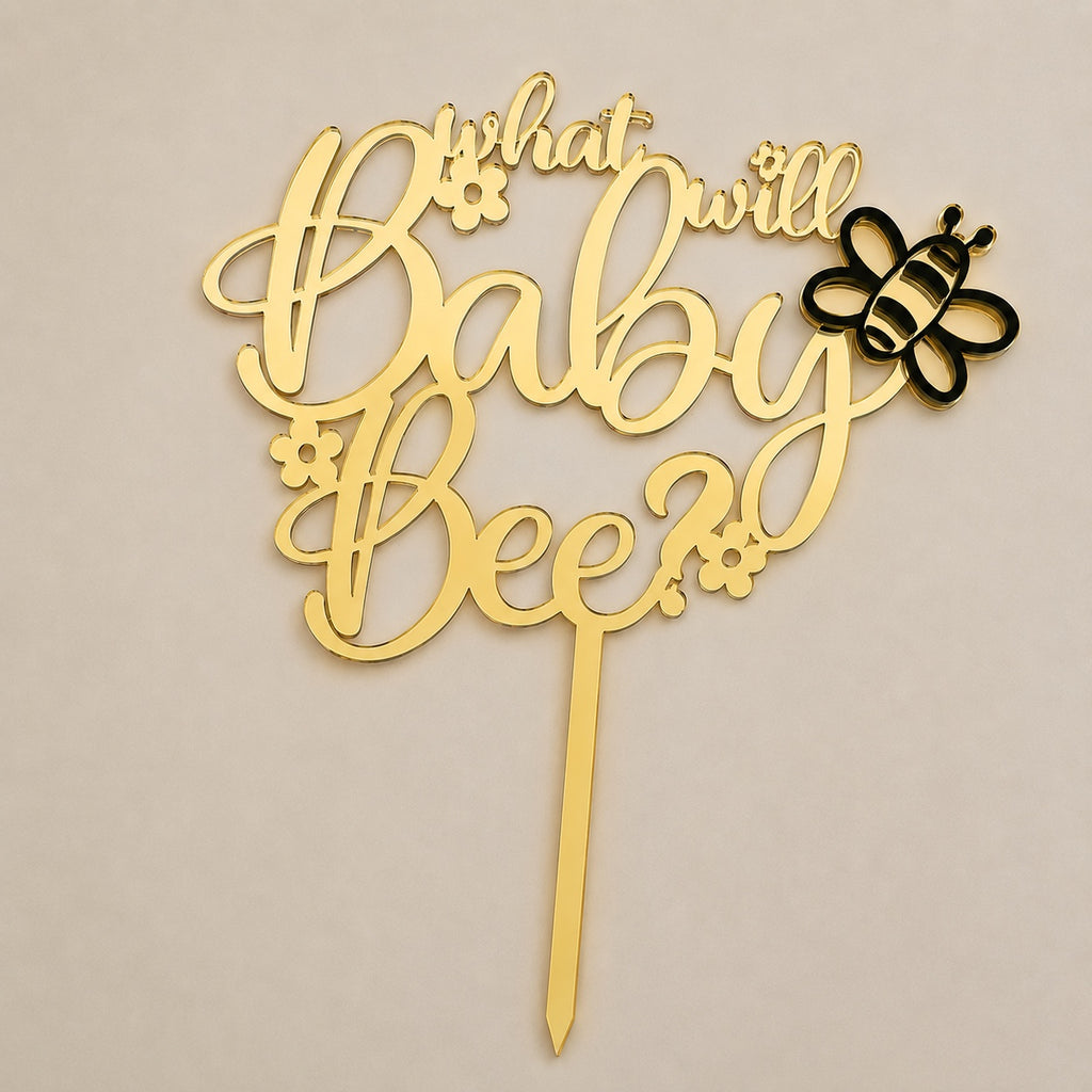 Gold and black dual-layer acrylic cake topper reading 'What will Baby Bee?' with bee design